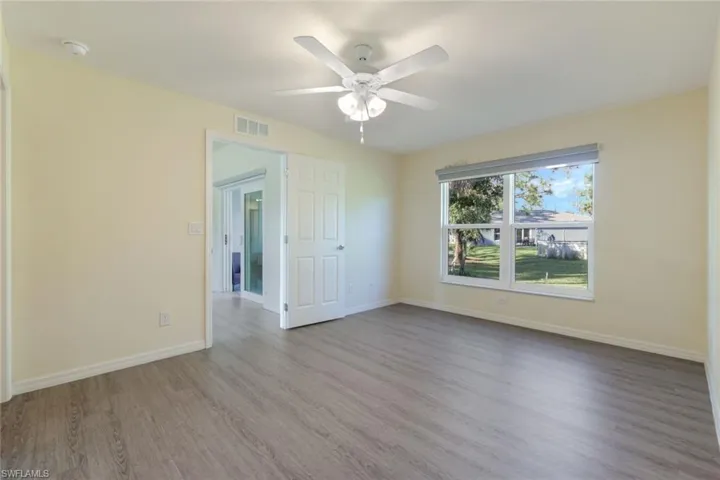 Unfurnished room featuring wood finished floors and a ceiling fan