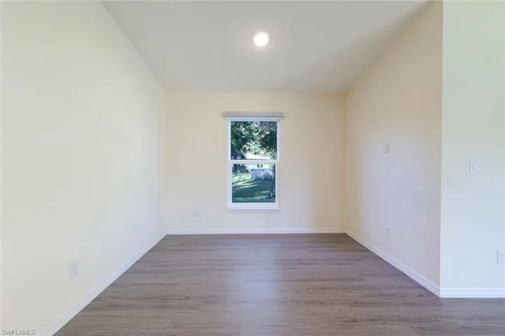 Empty room featuring wood finished floors and recessed lighting