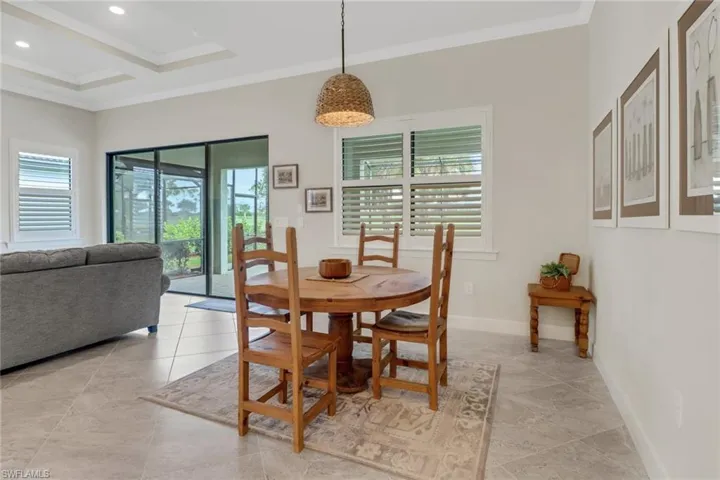 Dining area with crown molding, light tile patterned floors, and recessed lighting
