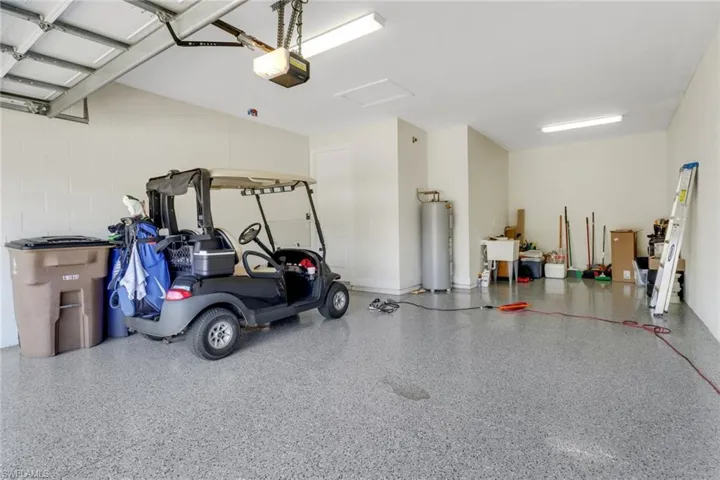 Garage with a garage door opener and electric water heater