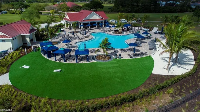 Community pool featuring a patio area and a yard