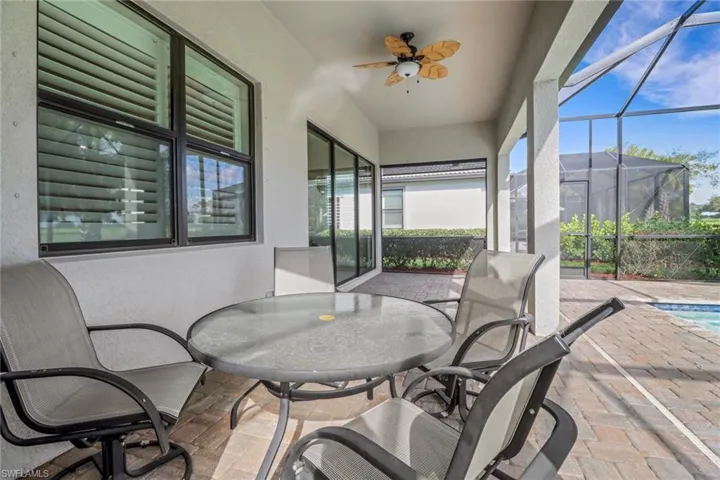Sunroom / solarium featuring ceiling fan, plenty of natural light, and outdoor dining space