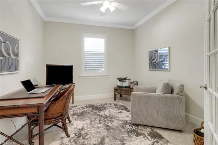 Home office featuring crown molding and a ceiling fan