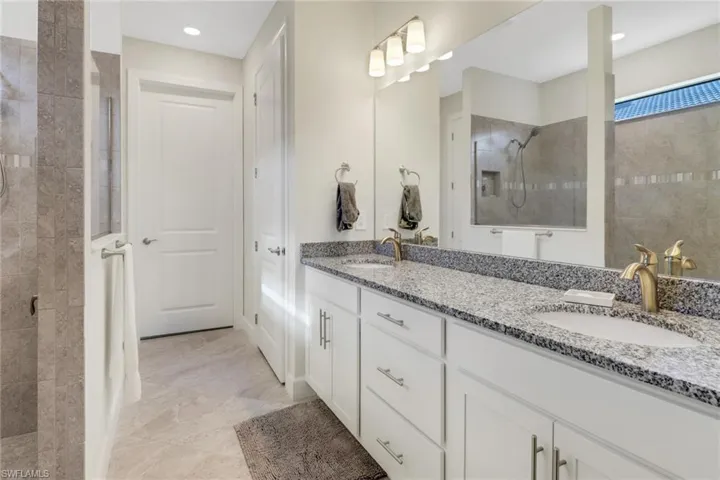 Full bathroom with a walk in shower and double vanity