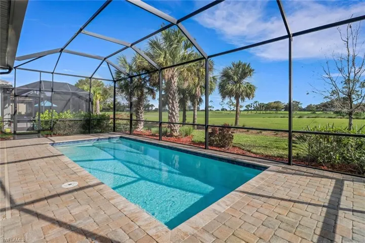 Swimming pool featuring a patio area and glass enclosure