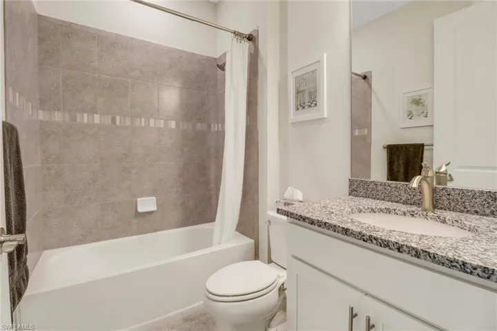 Full bath with vanity and shower / bath combination with curtain