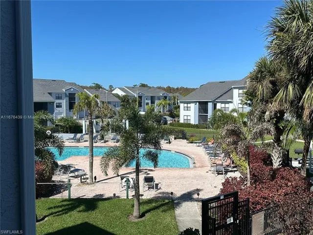 View of swimming pool with a lawn and a patio area