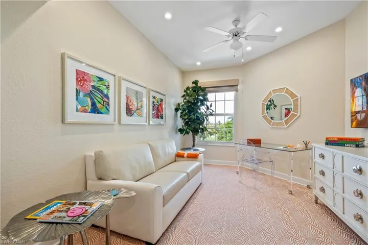 Sitting room featuring light colored carpet and ceiling fan