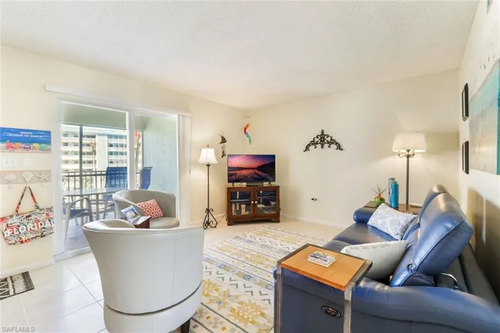 Tiled living room featuring a textured ceiling