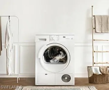 Laundry area with washer / clothes dryer and dark hardwood / wood-style floors