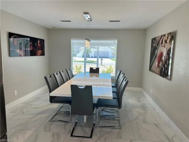 Dining room with light marble finish floors