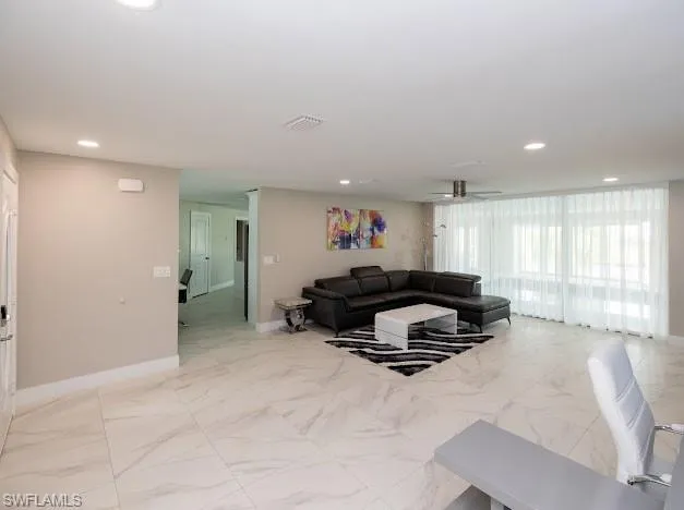 Living room with recessed lighting and a ceiling fan