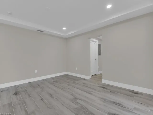 Spare room with light wood-style floors and recessed lighting