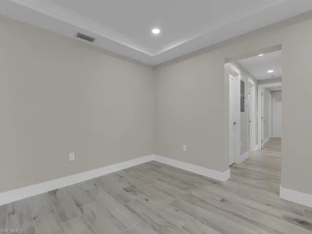 Empty room featuring light wood-style flooring and recessed lighting