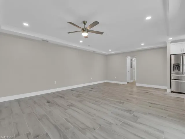 Unfurnished living room featuring wood tiled floors, recessed lighting, and a ceiling fan