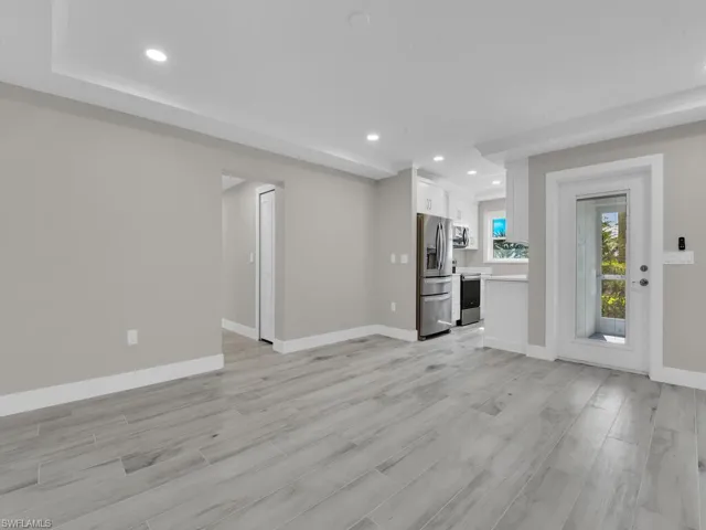 Unfurnished living room with recessed lighting and light wood-type flooring