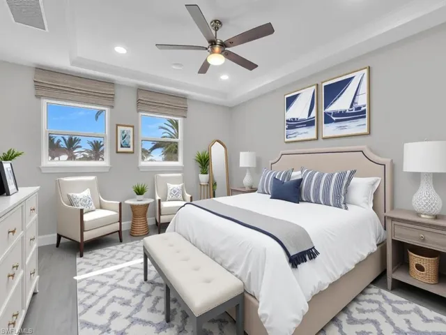 Bedroom with a tray ceiling, recessed lighting, ceiling fan, and light wood-type flooring