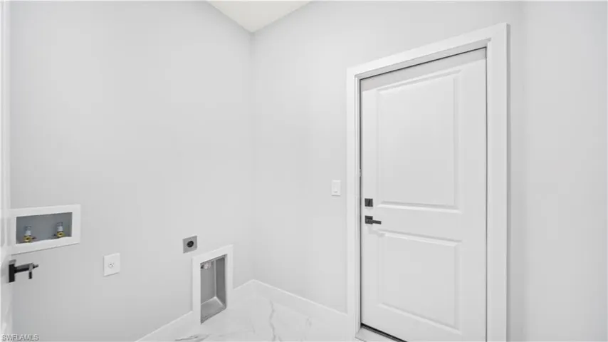 Washroom featuring light marble finish flooring, washer hookup, and electric dryer hookup