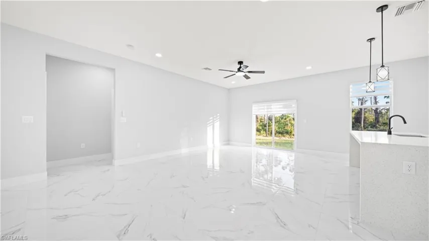 Unfurnished room featuring light marble finish flooring, recessed lighting, and ceiling fan