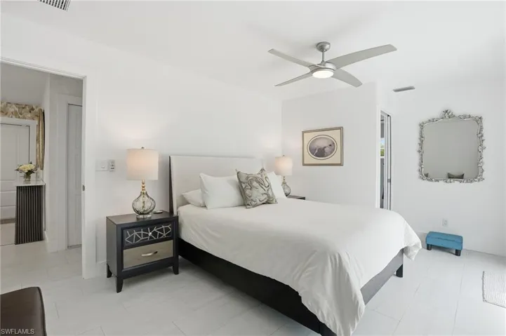 Bedroom featuring a ceiling fan and baseboards - Virtually Edited Image