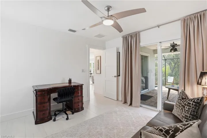 Home office featuring a ceiling fan and baseboards - Virtually Edited Image