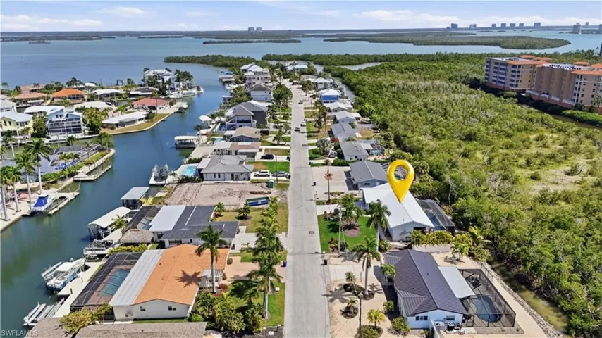 Aerial view of residential area featuring a nearby body of water - Virtually Edited Image