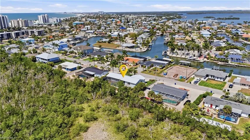Aerial perspective of suburban area with a large body of water - Virtually Edited Image