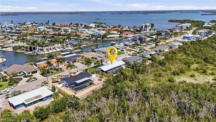 Aerial overview of property's location featuring nearby suburban area and a large body of water - Virtually Edited Image