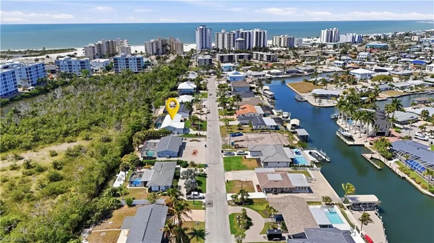 Aerial view of property and surrounding area with a nearby body of water - Virtually Edited Image