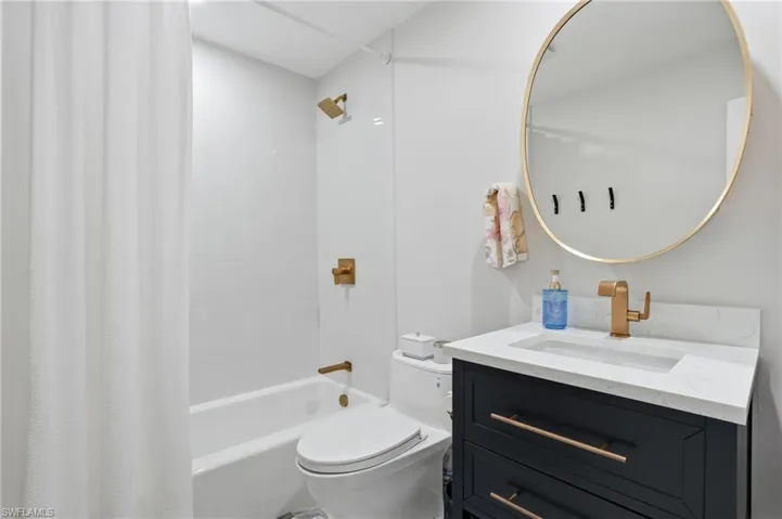 Bathroom featuring vanity and shower / bath combo with shower curtain - Virtually Edited Image