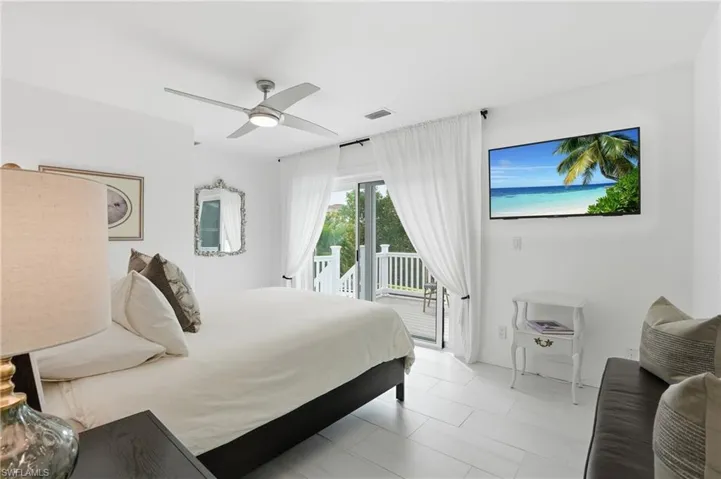 Bedroom with access to exterior and a ceiling fan - Virtually Edited Image