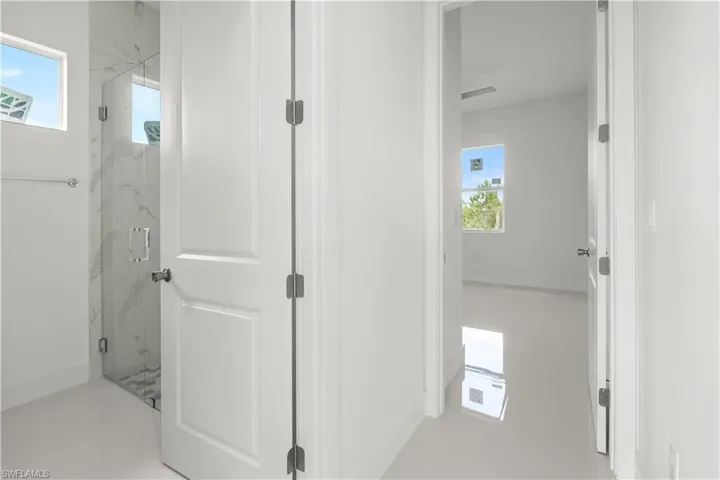 Corridor featuring healthy amount of natural light