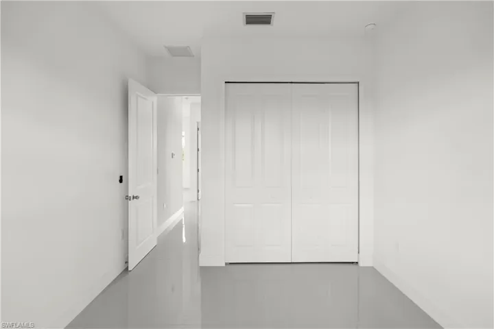 Unfurnished bedroom featuring baseboards and a closet