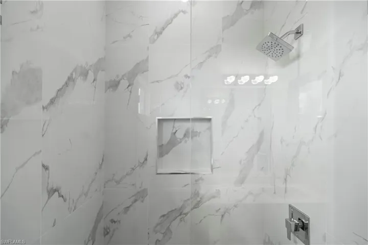Full bathroom featuring a marble finish shower