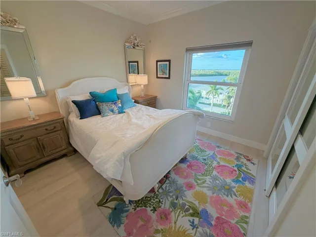 Bedroom featuring light wood-style floors and ornamental molding