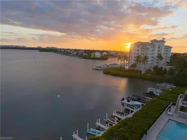 Water view featuring boat lift and a dock