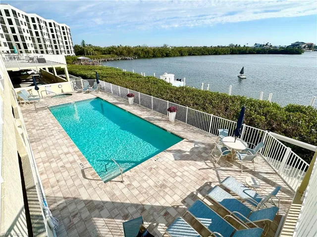 Community pool with a patio and a water view