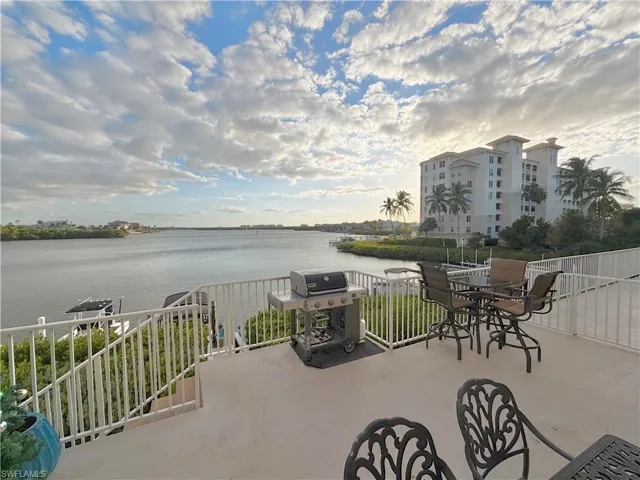 View of patio featuring grilling area and a water view