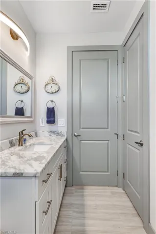 Guest bathroom features a large cabinet and a spacious linen closet.