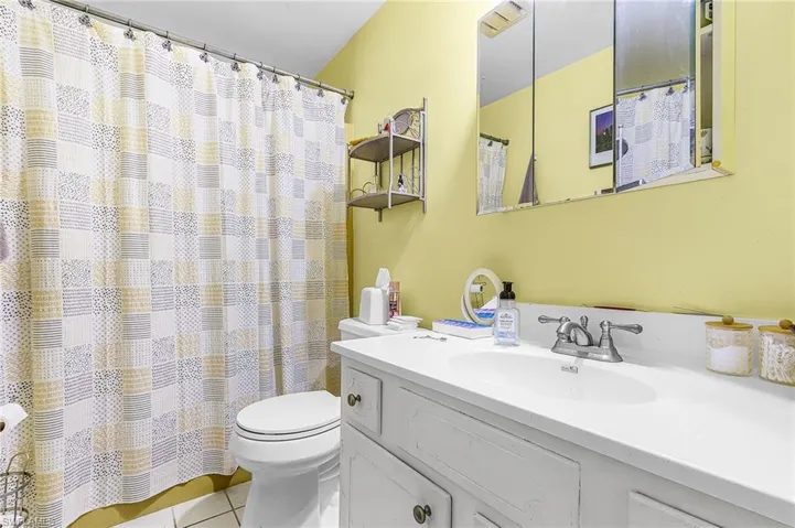 Bathroom featuring vanity, a shower with shower curtain, and light tile patterned floors