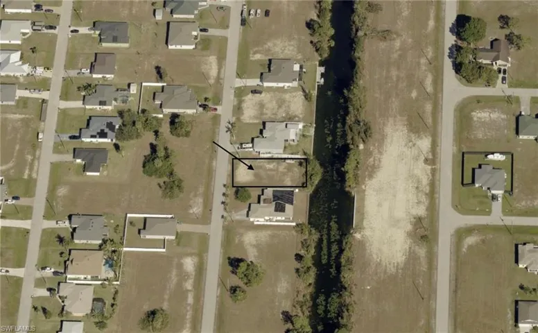 Aerial view of property's location featuring nearby suburban area