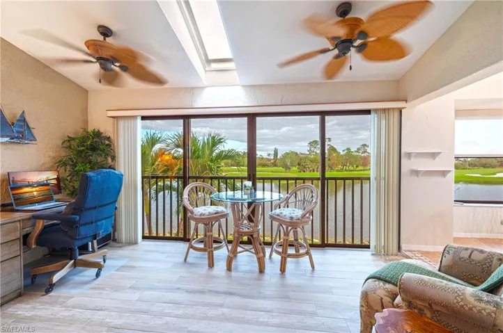 Sunroom / solarium featuring ceiling fan, a wealth of natural light, and a skylight