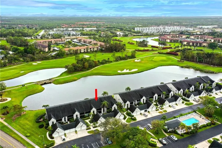 Birds eye view of property with a water view