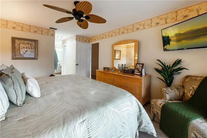 Bedroom with hardwood / wood-style flooring and ceiling fan