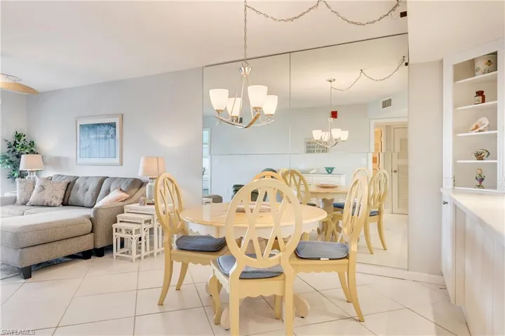 Dining room with a chandelier and light tile patterned floors
