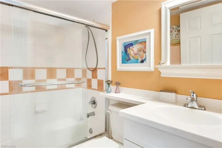 Bathroom with vanity and shower / bath combination with glass door
