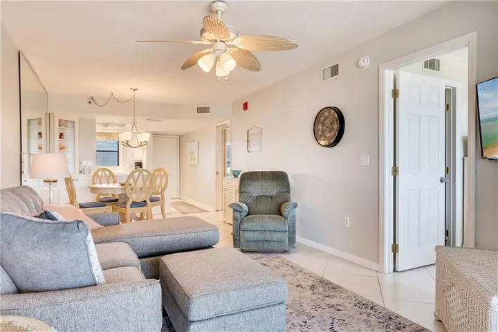 Living room featuring ceiling fan and light tile patterned flooring
