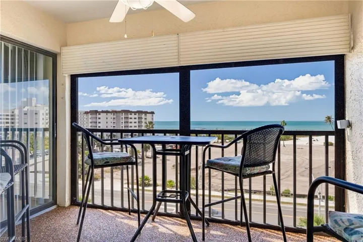 Unfurnished sunroom with a water view and a textured wall