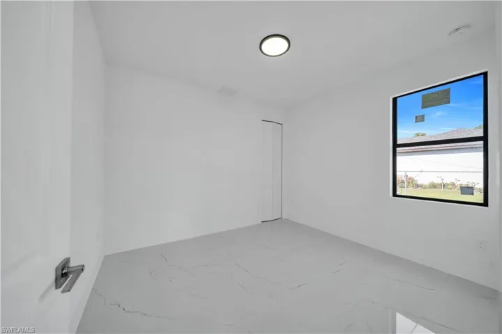 Empty room with light marble finish floors and baseboards