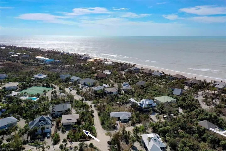 Aerial view with a water view and a beach view